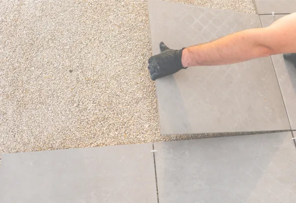 Porcelain and Indian stone patios can create durable, stylish outdoor spaces for relaxing, dining and everyday garden use. || The team can help compare finishes, layouts, levels and pathways so the final patio feels practical and well planned.